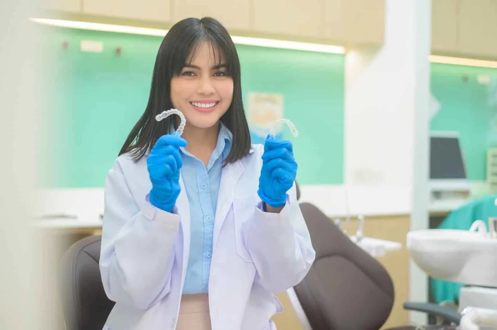 A Young Female Dentist Holding Invisalign In Dental Clinic, Teeth Check-up And Healthy Teeth
